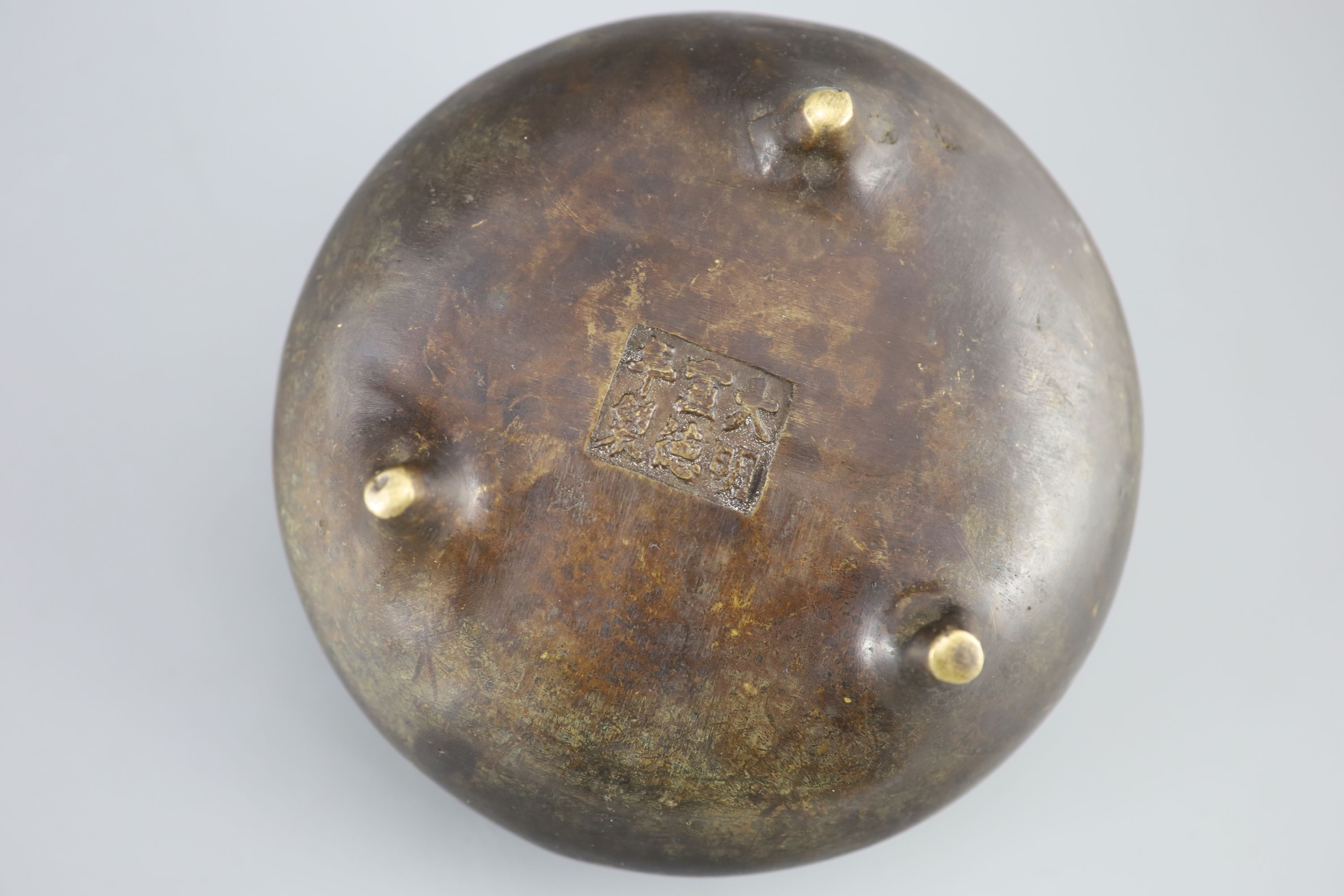 A Chinese bronze tripod censer, Xuande mark but 19th century, 16cm diameter